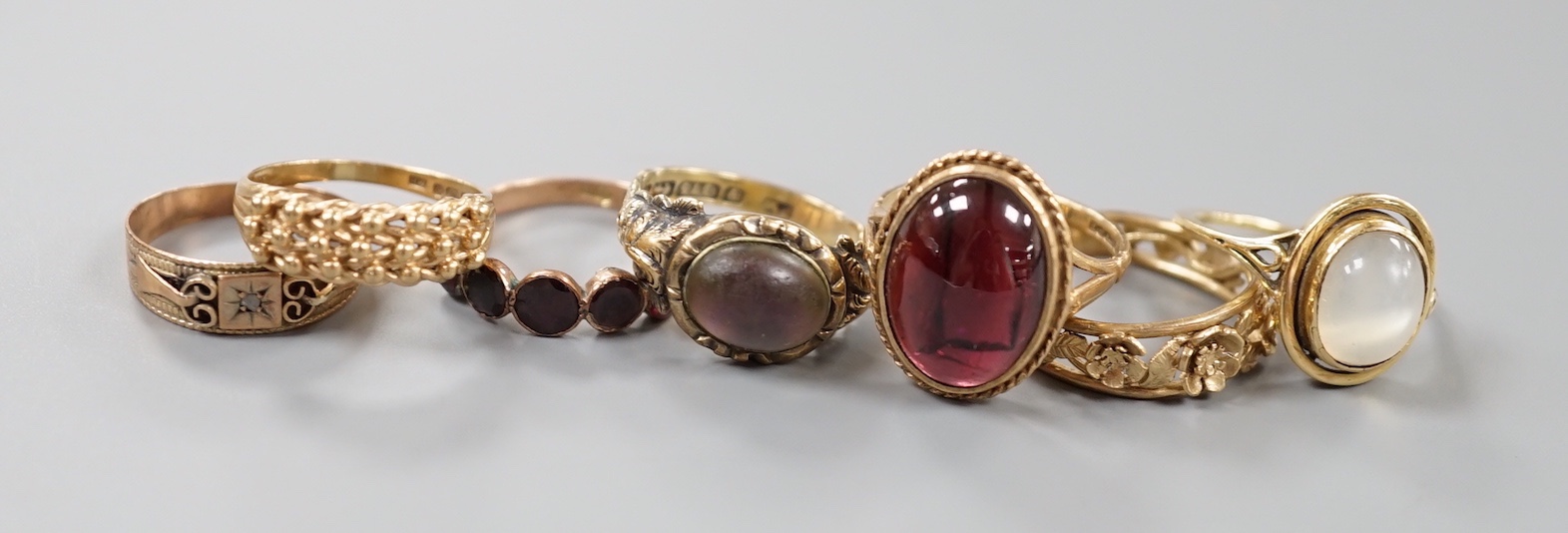 Six assorted Victorian and later 9ct gold or 9ct gold and gem set dress rings, including cabochon garnet and foliate band and a yellow metal and moonstone ring.